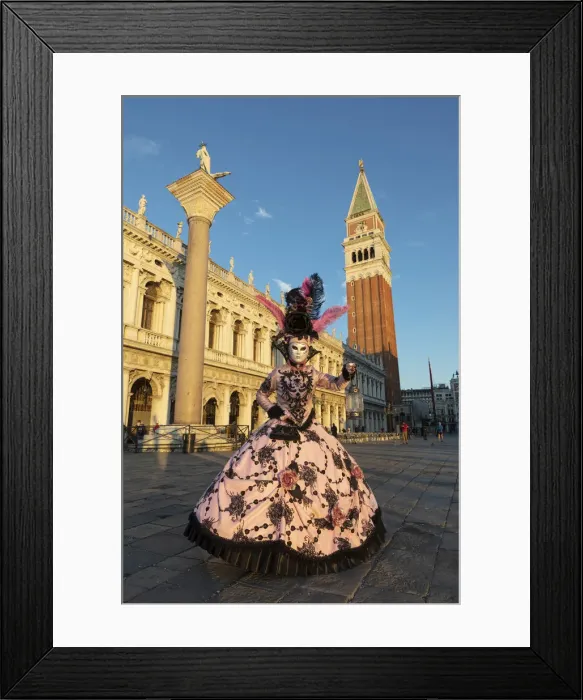 Framed Print : A woman in a colourful costume walks through St. Mark