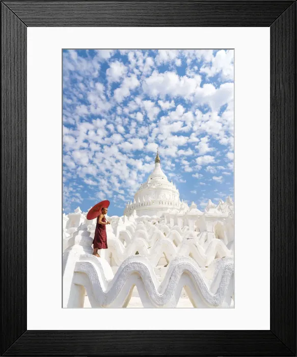 Framed Print : Novice monk with an umbrella standing at white Hsinbyume pagoda