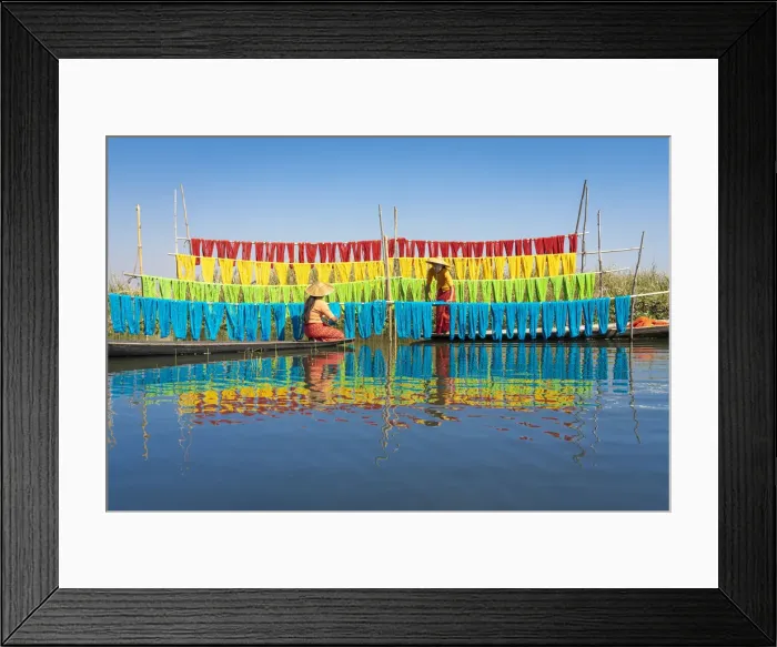 Framed Print : Two women hanging dyed yarn from boats to dry in a traditional weaving village on Lake Framed Print : Two women hanging dyed yarn from boats to dry in a traditional weaving village on Lake