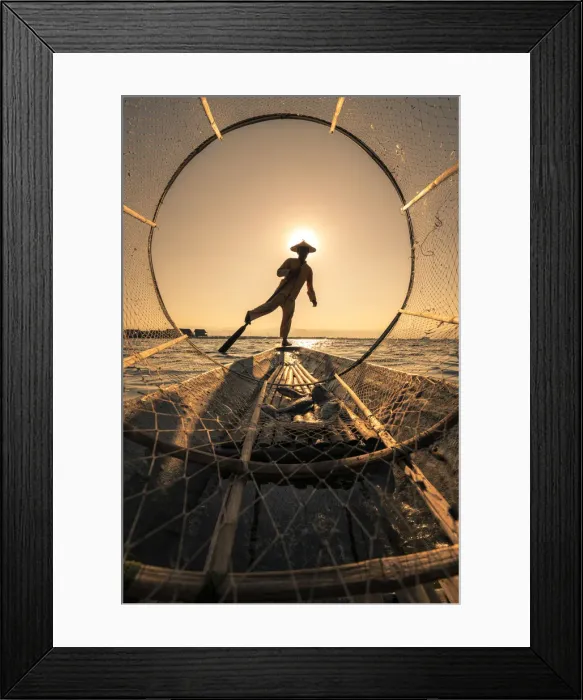 Framed Print : Traditional leg-rowing fisherman viewed through conical fishing net rowing a boat on Lake Framed Print : Traditional leg-rowing fisherman viewed through conical fishing net rowing a boat on Lake