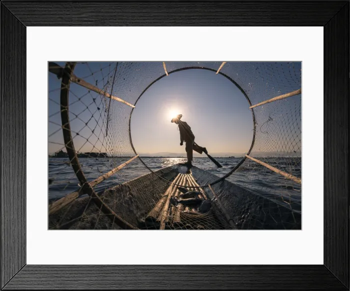 Framed Print : Traditional leg-rowing fisherman viewed through conical fishing net rowing a boat on Lake Framed Print : Traditional leg-rowing fisherman viewed through conical fishing net rowing a boat on Lake