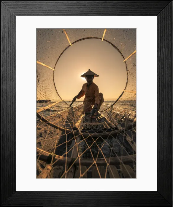 Framed Print : Traditional fisherman viewed through conical fishing net collecting fish on a boat Framed Print : Traditional fisherman viewed through conical fishing net collecting fish on a boat