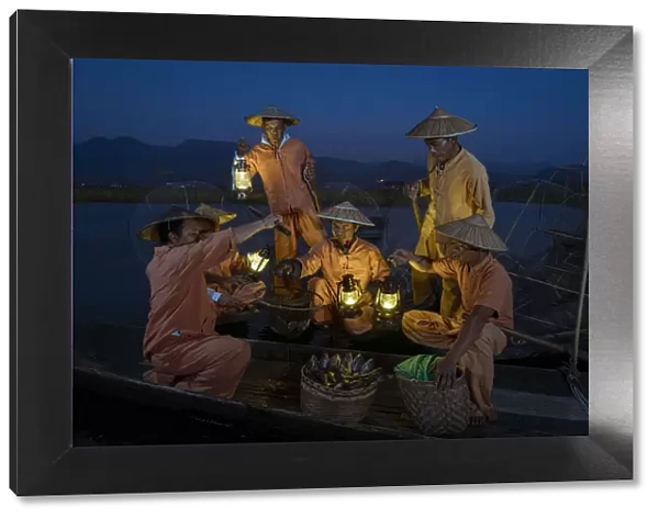 Traditional fishermen on Lake Inle having a supper on boats together at night, Lake Inle
