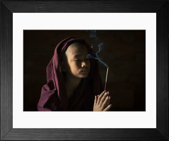 Framed Print : Novice monk holding a lit incense stick while praying inside a temple, UNESCO, Bagan Framed Print : Novice monk holding a lit incense stick while praying inside a temple, UNESCO, Bagan