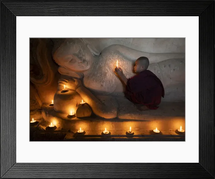 Framed Print : A novice monk holding a burning candle while praying by Buddha statue, UNESCO, Bagan Framed Print : A novice monk holding a burning candle while praying by Buddha statue, UNESCO, Bagan