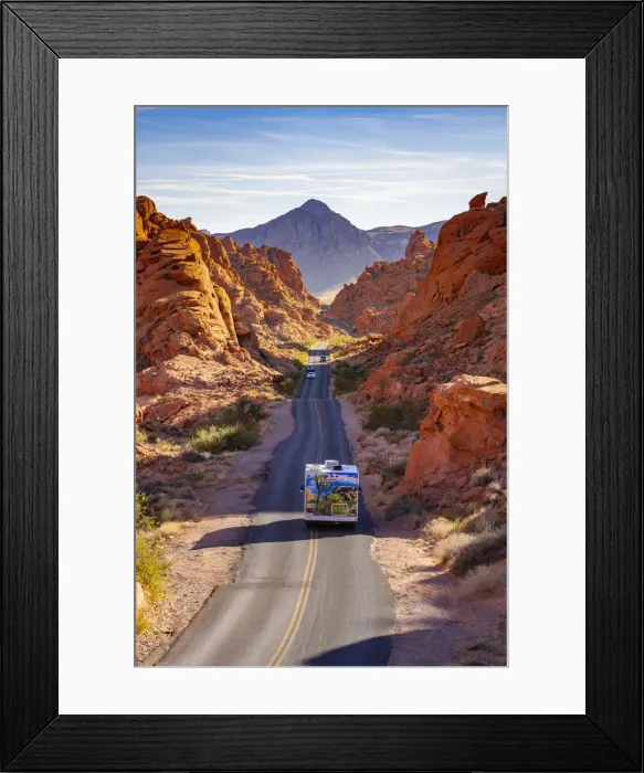 Framed Print : Campervan and cars driving on a straight road between red rocks during sunny day