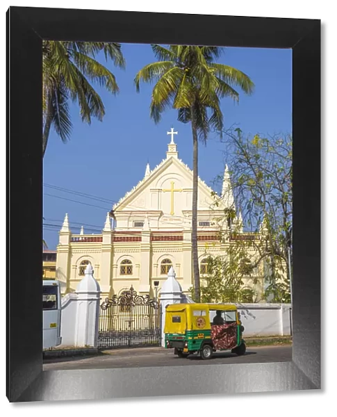 India, Kerala, Cochin - Kochi, Fort Kochi, Auto rickshaw passing infront of the Santa
