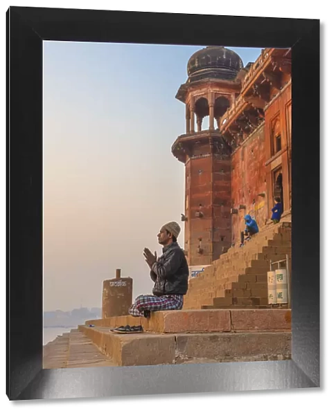 Hinduist practicising meditation, Cityscape from Ganges, Varanasi, Uttar Pradesh, India