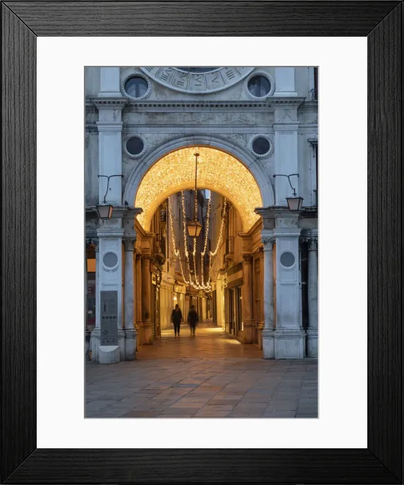 Framed Print : People walk through the illuminated arcade under the clock Tower, St Framed Print : People walk through the illuminated arcade under the clock Tower, St