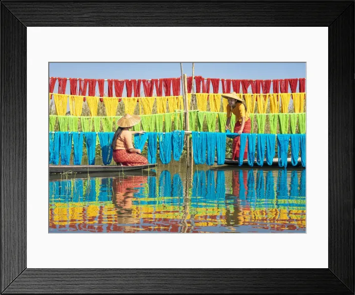Framed Print : Two women hanging dyed yarn from boats to dry in a traditional weaving village on Lake Framed Print : Two women hanging dyed yarn from boats to dry in a traditional weaving village on Lake