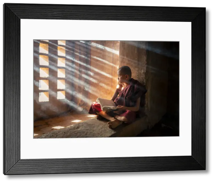 Framed Print : A young monk reading by a window inside a temple, UNESCO, Bagan, Mandalay Region, Myanmar Framed Print : A young monk reading by a window inside a temple, UNESCO, Bagan, Mandalay Region, Myanmar