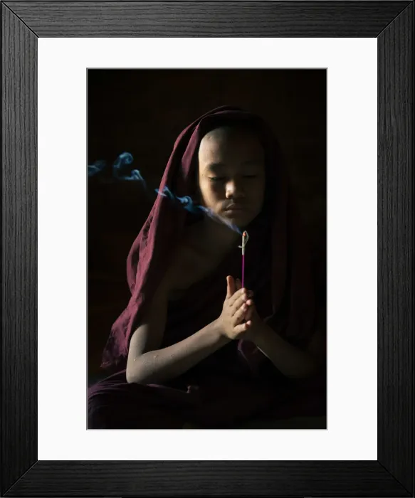Framed Print : Novice monk holding a lit incense stick while praying inside a temple, UNESCO, Bagan Framed Print : Novice monk holding a lit incense stick while praying inside a temple, UNESCO, Bagan