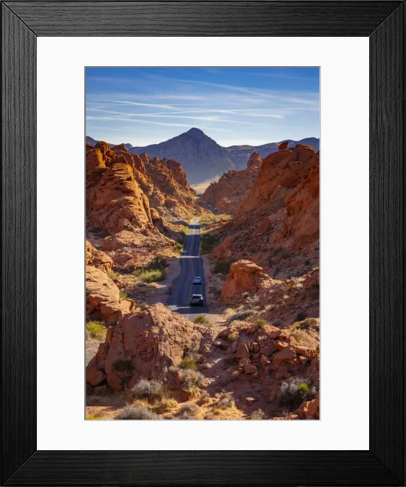 Framed Print : Cars driving on a straight road between red rocks during sunny day