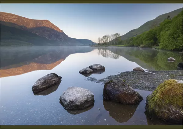 Mirror reflections at dawn on Llyn Cwellyn in Snowdonia National Park, Wales, UK. Spring