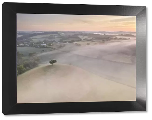 Misty sunrise over the beautiful countryside of Mid Devon, England. Spring (May) 2020