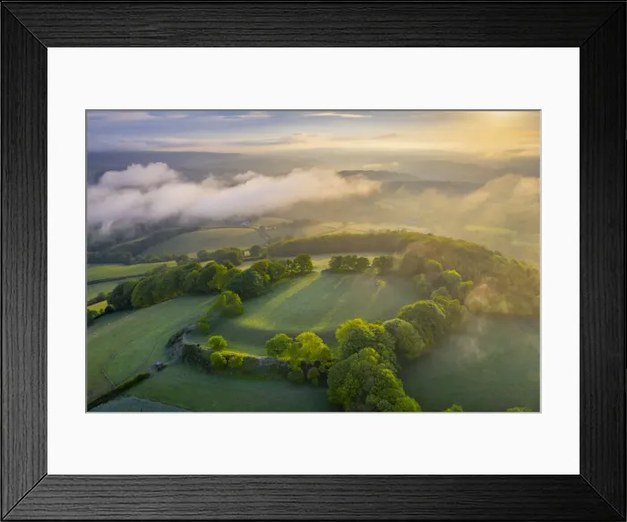Framed Print : Aerial vista of Cadbury Castle Iron Age Hillfort in early morning sunlight, Devon Framed Print : Aerial vista of Cadbury Castle Iron Age Hillfort in early morning sunlight, Devon
