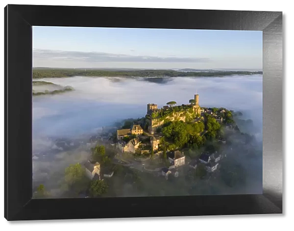 An aerial view of the hilltop village of Turenne at sunrise surrounded by mist, Correze