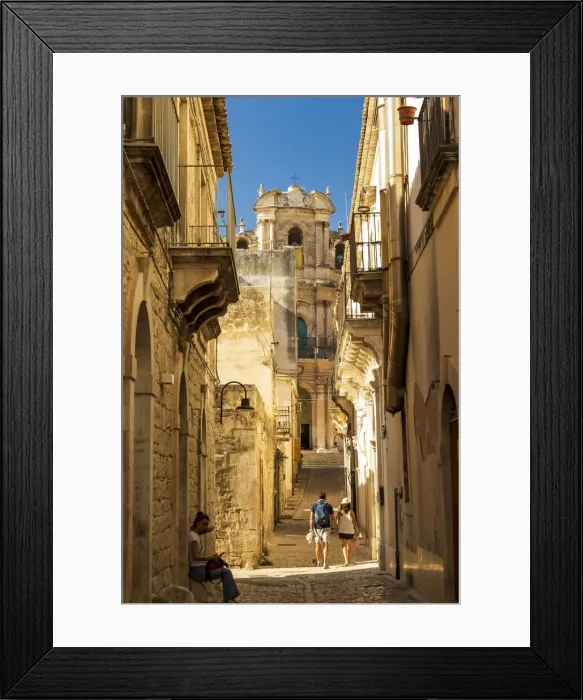 Framed Print : Scicli, Sicily. People walking in the narrow streets with San Giovanni Evangelista Framed Print : Scicli, Sicily. People walking in the narrow streets with San Giovanni Evangelista
