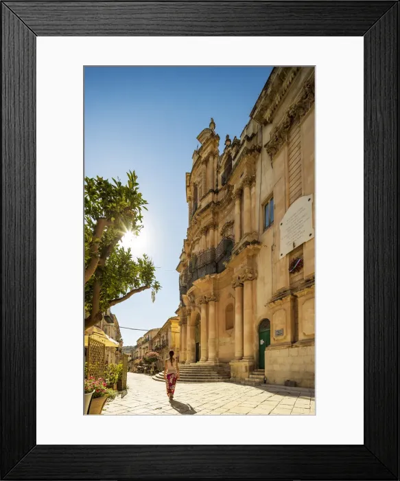 Framed Print : Scicli, Sicily. A woman walking in front of San Giovanni Evangelista church on a sunny Framed Print : Scicli, Sicily. A woman walking in front of San Giovanni Evangelista church on a sunny