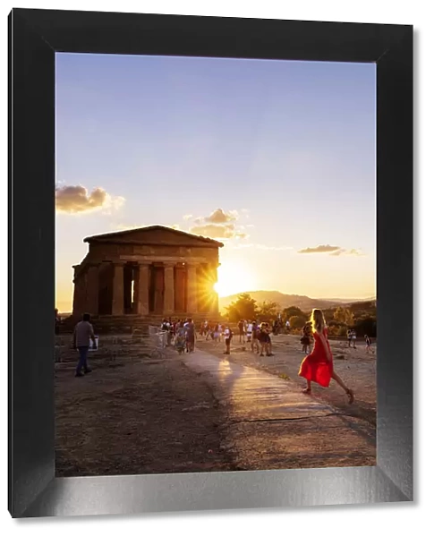 Agrigento, Sicily. People visiting Concordia Temple in the Valley of Temples at sunset