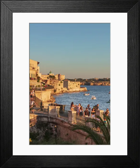 Framed Print : Siracusa, Sicily. People walking by the sea at sunset