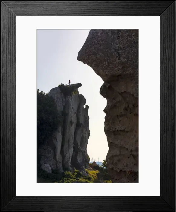Framed Print : Montalbano Elicona, Messina. A man walking on the edge of the rock formations in Framed Print : Montalbano Elicona, Messina. A man walking on the edge of the rock formations in