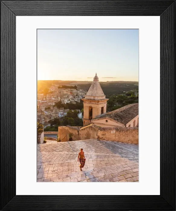 Framed Print : Ragusa Ibla, Sicily. A woman walking on the stairs with Ragusa old town in the background Framed Print : Ragusa Ibla, Sicily. A woman walking on the stairs with Ragusa old town in the background