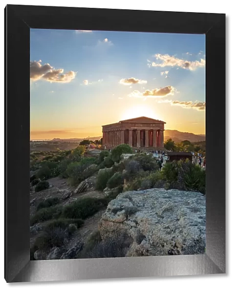 Agrigento, Sicily. Tourists visiting Concordia Temple in the Valley of Temples at sunset