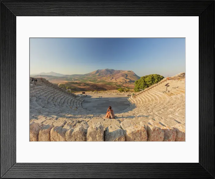 Framed Print : Segesta, Sicily. A woman sitting alone in the greek theater of Segesta at sunset Framed Print : Segesta, Sicily. A woman sitting alone in the greek theater of Segesta at sunset