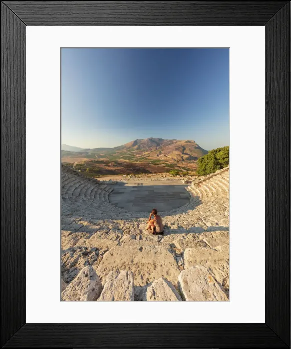 Framed Print : Segesta, Sicily. A woman sitting alone in the greek theater of Segesta at sunset Framed Print : Segesta, Sicily. A woman sitting alone in the greek theater of Segesta at sunset