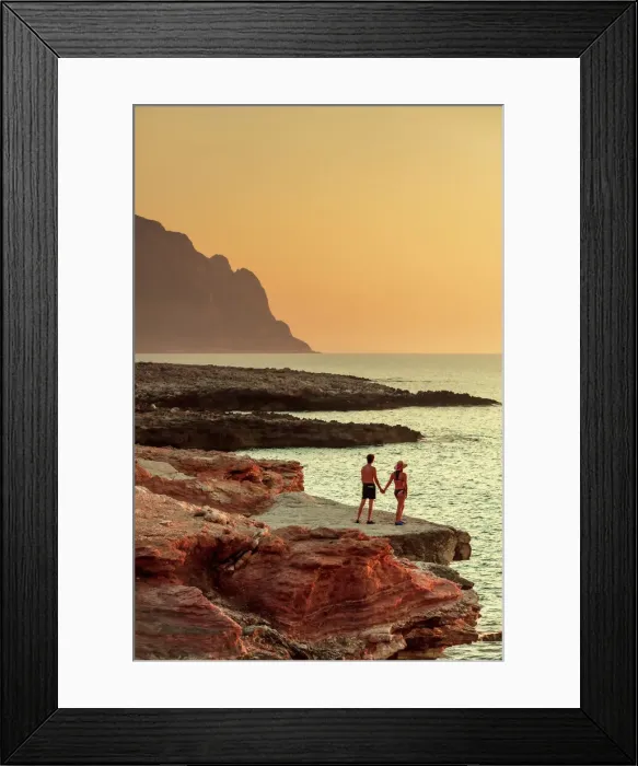 Framed Print : San Vito lo Capo, Sicily. A couple enjoying the sunset on the rock formations along Framed Print : San Vito lo Capo, Sicily. A couple enjoying the sunset on the rock formations along