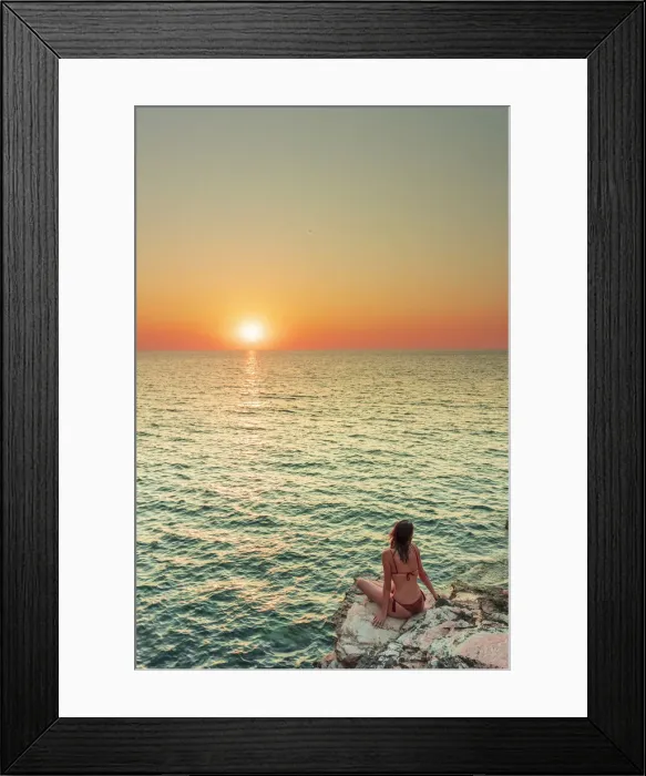Framed Print : San Vito lo Capo, Sicily. A person enjoying the view of the sun setting along the rock Framed Print : San Vito lo Capo, Sicily. A person enjoying the view of the sun setting along the rock