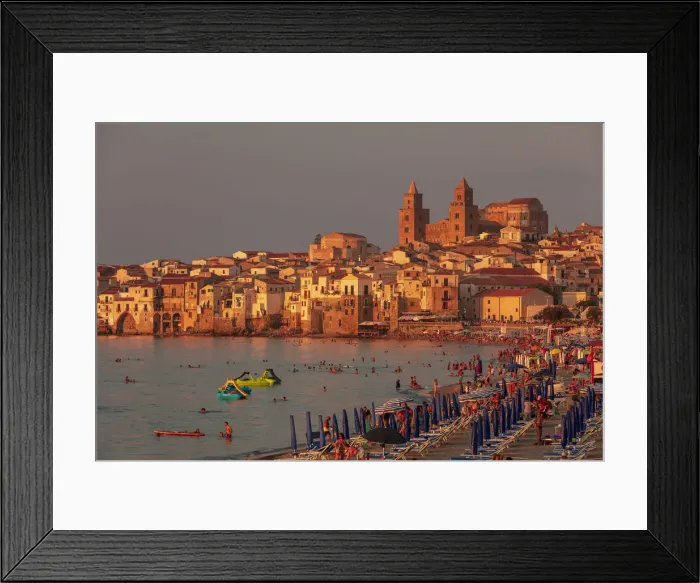 Framed Print : Cefaluaa, Sicily. People under beach umbrellas with the Cathedral in the background Framed Print : Cefaluaa, Sicily. People under beach umbrellas with the Cathedral in the background