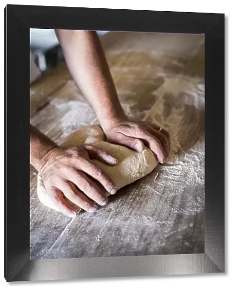 Italy, Tuscany, Serchio Valley, A baker kneading spelt dough
