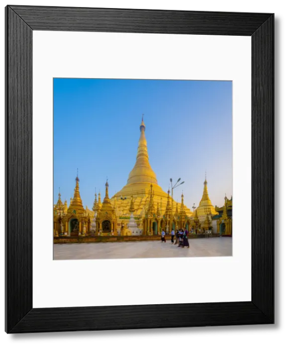 Framed Print : Tourists at gilded Shwedagon Pagoda against clear sky at sunrise, Yangon, Yangon Region Framed Print : Tourists at gilded Shwedagon Pagoda against clear sky at sunrise, Yangon, Yangon Region