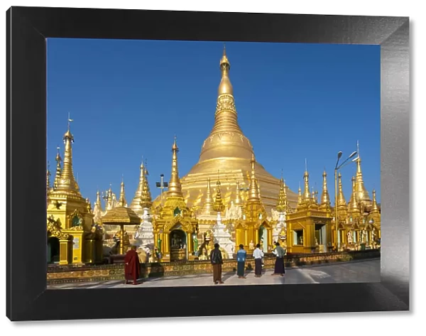 Tourists at gilded Shwedagon Pagoda against clear sky, Yangon, Yangon Region, Myanmar