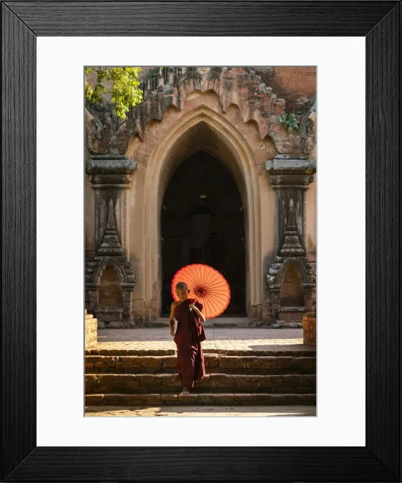 Framed Print : Novice Buddhist monk with red umbrella walking away from temple, Bagan, Mandalay Region Framed Print : Novice Buddhist monk with red umbrella walking away from temple, Bagan, Mandalay Region
