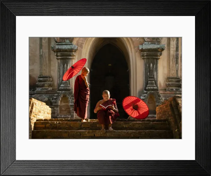 Framed Print : Two novice Buddhist monks with red umbrellas reading by temple, Bagan, Mandalay Region Framed Print : Two novice Buddhist monks with red umbrellas reading by temple, Bagan, Mandalay Region