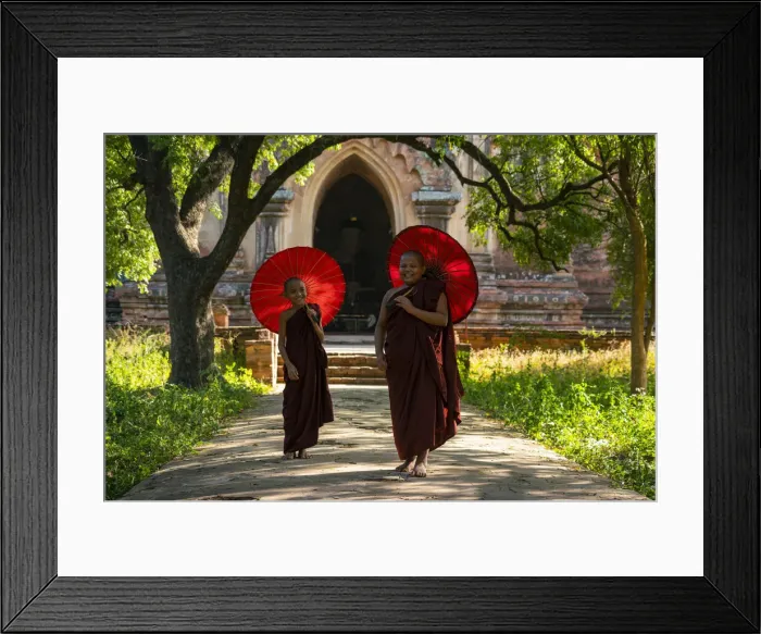 Framed Print : Two novice Buddhist monks with red umbrellas walking away from temple, Bagan Framed Print : Two novice Buddhist monks with red umbrellas walking away from temple, Bagan