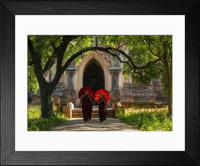 Framed Print : Two novice Buddhist monks with red umbrellas walking away from temple, Bagan Framed Print : Two novice Buddhist monks with red umbrellas walking away from temple, Bagan
