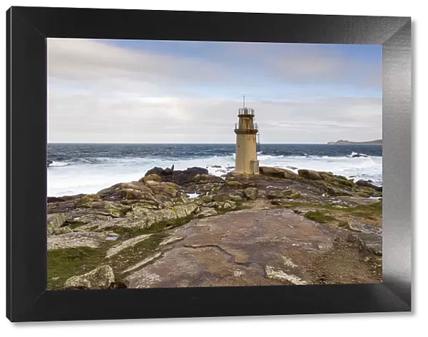 Spain, Galicia, Costa da Morte, Muxia, Lighthouse on the rocks by the Nosa Seanora da