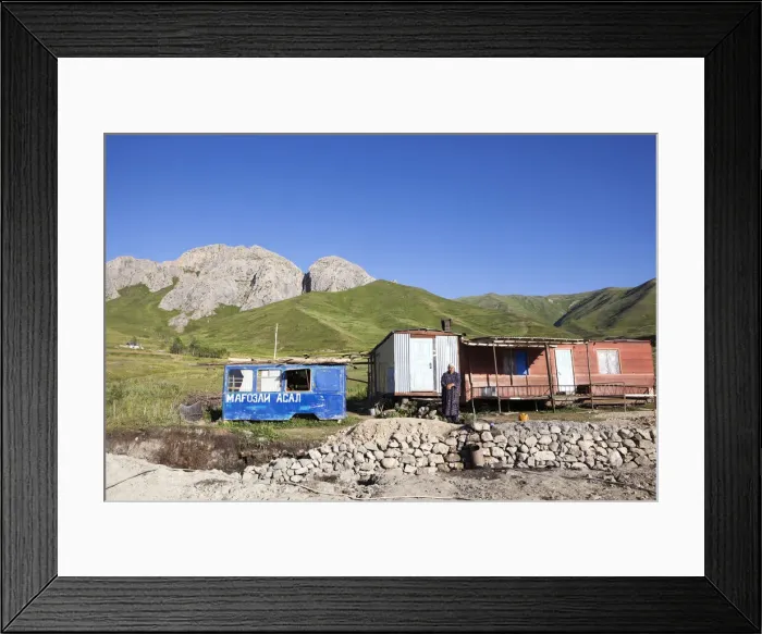 Framed Print : A Tajik woman stands outside her home on the Pamir Highway; Tajikistan Framed Print : A Tajik woman stands outside her home on the Pamir Highway; Tajikistan