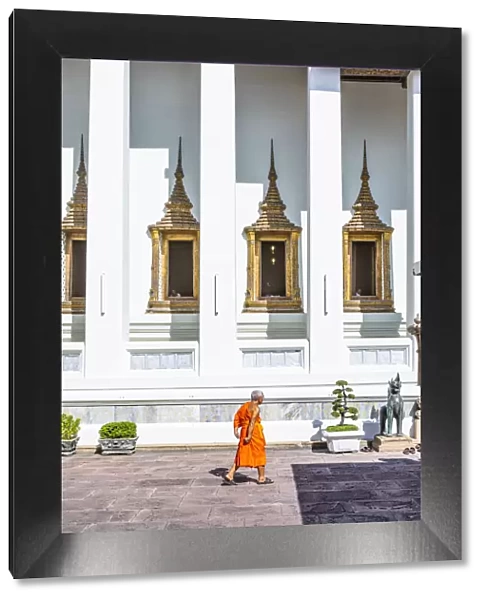 A monk walking in Wat Pho (Temple of the Reclining Buddha), Bangkok, Thailand