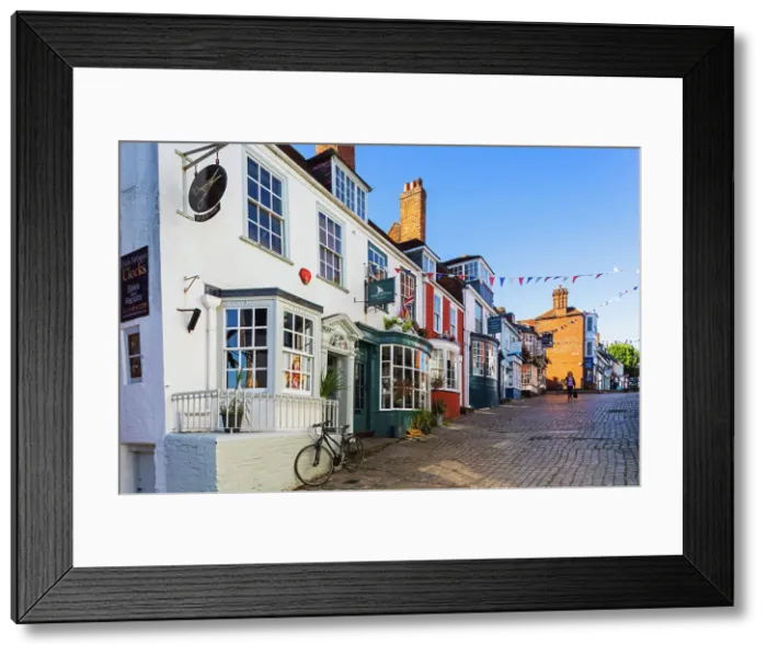 Framed Print : England, Hampshire, The New Forest, Lymington, Colourful Shop Fronts on Quay Hill Framed Print : England, Hampshire, The New Forest, Lymington, Colourful Shop Fronts on Quay Hill