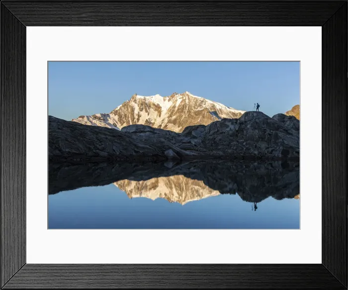 Framed Print : Photographer on rocks admiring Monte Rosa mirrored in water from Monte Moro Pass Framed Print : Photographer on rocks admiring Monte Rosa mirrored in water from Monte Moro Pass