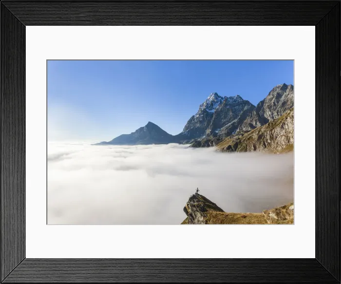 Framed Print : Hiker on top of rocks admiring Monviso emerging from fog, Crissolo, Po Valley Framed Print : Hiker on top of rocks admiring Monviso emerging from fog, Crissolo, Po Valley