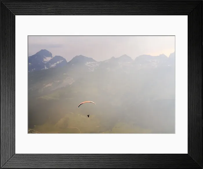 Framed Print : Paraglide flying in the mist over mountains of upper Engadine Graubunden, Switzerland