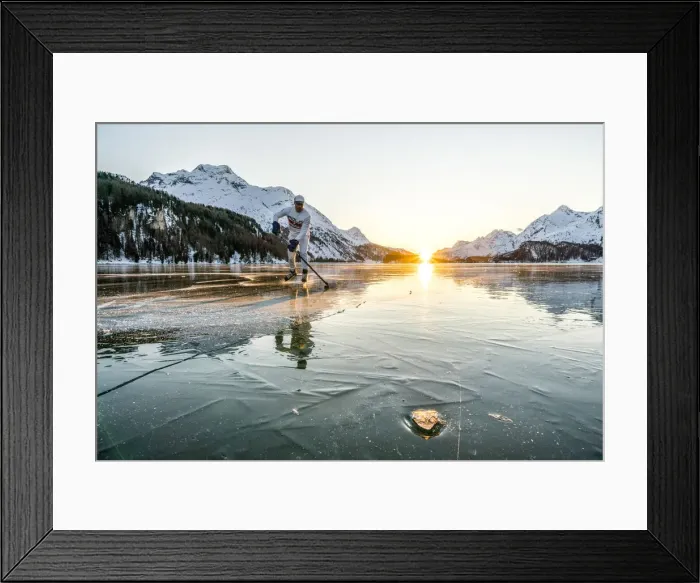 Framed Print : Young man playing ice hockey on frozen Lake Sils at sunset, Graubunden, Engadine Framed Print : Young man playing ice hockey on frozen Lake Sils at sunset, Graubunden, Engadine