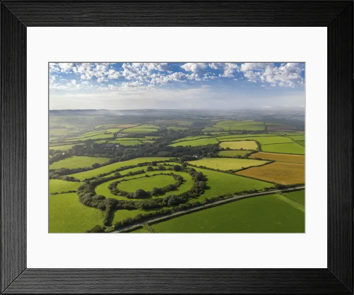 Framed Print : Aerial vista of Tregeare Rounds Iron Age Hillfort surrounded by Cornish countryside Framed Print : Aerial vista of Tregeare Rounds Iron Age Hillfort surrounded by Cornish countryside