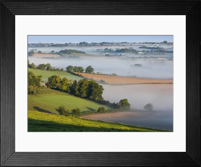 Framed Print : Mist lying over the Cranborne Chase with Shaftesbury in the distance, Wiltshire, England Framed Print : Mist lying over the Cranborne Chase with Shaftesbury in the distance, Wiltshire, England